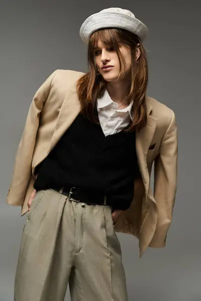 A fashionable young man showcases his unique style with a chic outfit and confident pose. — Stock Photo