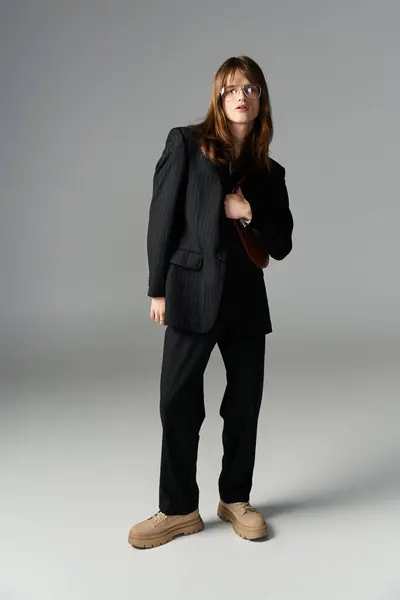 A young person showcases their unique fashion sense with confidence in a sleek outfit. — Stock Photo