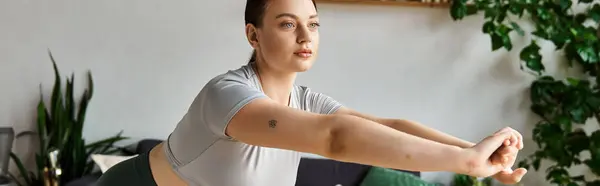 A young sportive woman exercises in a crop top, enjoying her home workout session. — Stock Photo