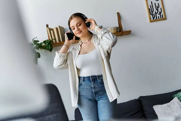 Молода жінка, одягнена випадково, слухає музику вдома. — Stock Photo