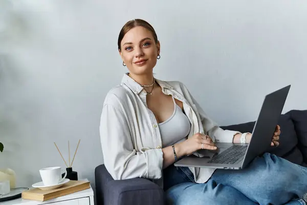 The relaxed woman engages with her laptop, balancing work and comfort in a stylish home environment. — Stock Photo