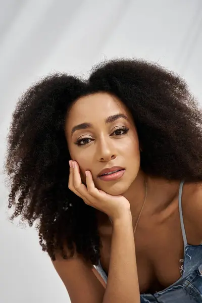 With a thoughtful expression, a stylish young woman embodies elegance and confidence in her attire. — Stock Photo