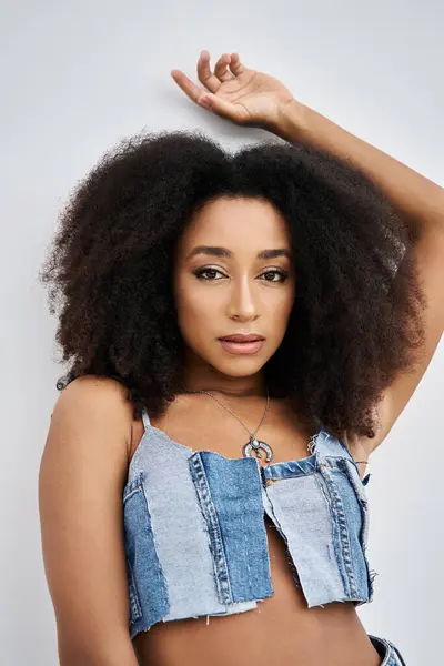 This confident young woman showcases her fashion sense and natural beauty in a unique outfit. — Stock Photo