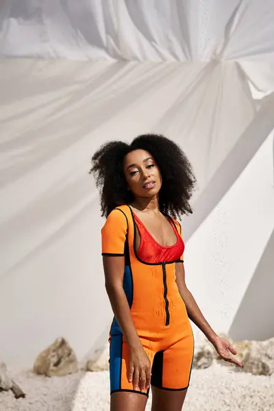 A confident young woman showcases her unique style in a colorful outfit, radiating beauty. — Stock Photo