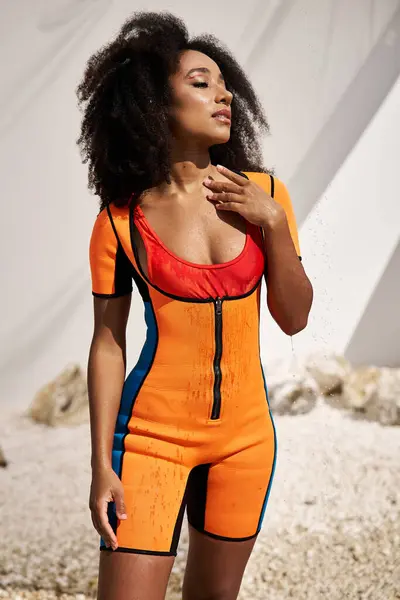 A beautiful young woman showcases her stylish outfit against a bright, artistic backdrop. — Stock Photo