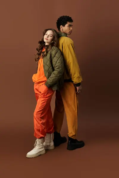 A stylish young couple showcases their autumn fashion with vibrant outfits and cozy layers. — Stock Photo