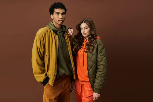 A young couple showcases their fashionable autumn outfits, embracing seasonal colors and styles. — Stock Photo
