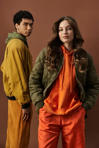 A fashionable young couple showcases their autumn outfits, radiating stylish energy together. — Stock Photo