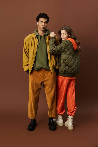 A stylish couple displays trendy autumn outfits, blending colors and textures. — Stock Photo