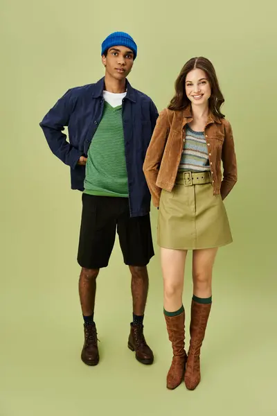A fashionable couple embraces the autumn spirit with vibrant attire and bold styles. — Stock Photo