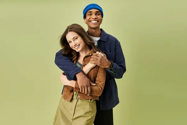 A stylish couple shares a light hearted moment showcasing their trendy autumn outfits together. — Stock Photo