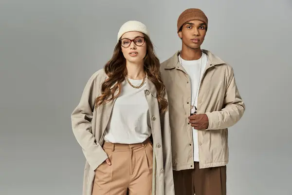 A stylish young couple elegantly displays their vibrant autumn outfits, embracing the season. — Stock Photo