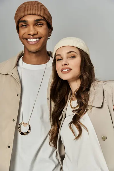 A fashionable duo showcases their vibrant autumn attire, exuding warmth and joy indoors. — Stock Photo