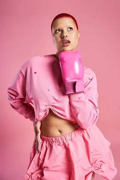 Boldly showcasing her unique style, a young woman poses with boxing gloves in a vibrant studio setting. — Stock Photo