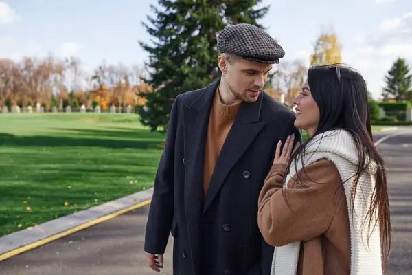 A loving couple enjoys an intimate moment while walking through a picturesque autumn landscape. — Stock Photo