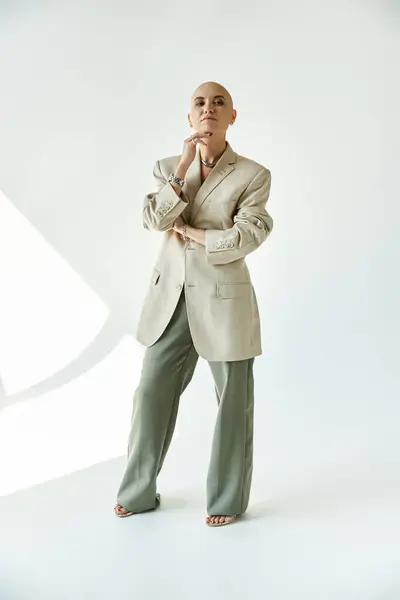 A young bald woman exudes confidence while showcasing her unique style in an oversized blazer. — Stock Photo