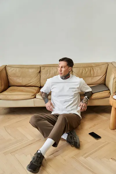The handsome individual enjoys a peaceful moment at home, sitting comfortably on the floor. — Stock Photo