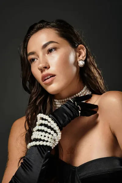 A young woman exudes elegance with pearl accessories, capturing a moment of refined beauty. — Stock Photo