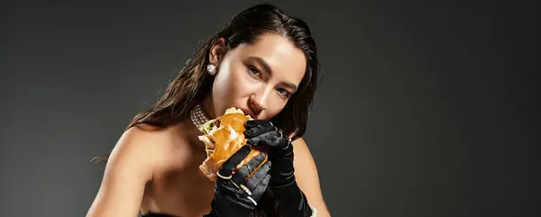 A sophisticated young woman savors a gourmet meal while dressed elegantly, exuding charm. — Stock Photo
