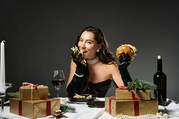 A young woman delights in gourmet cuisine while seated at a beautifully decorated table. — Stock Photo