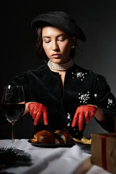 A stylish young woman thoughtfully serves exquisite dishes at an elegant event. — Stock Photo