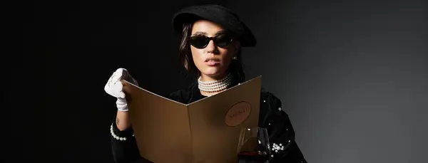 A stylish young woman studies the menu intently during an evening out. — Stock Photo