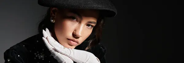 A young woman exudes elegance wearing a sophisticated outfit along with striking accessories. — Stock Photo