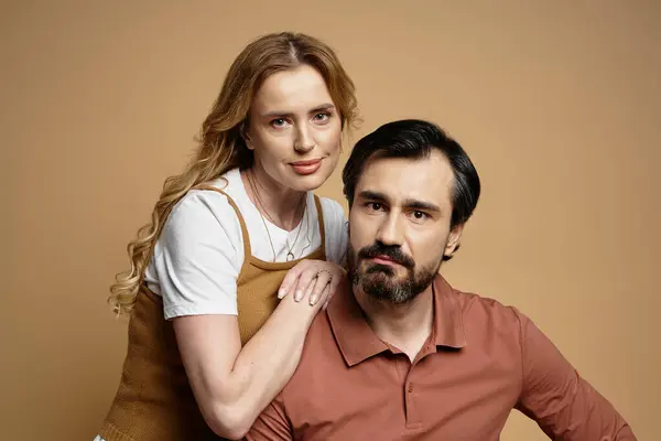 A middle aged couple exudes connection and warmth with gentle smiles in a soft lit setting. — Stock Photo