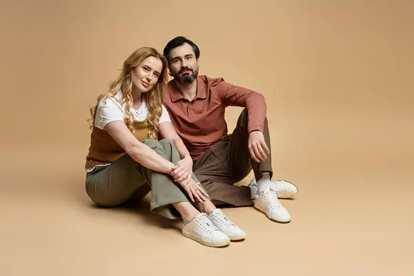 A middle aged couple sits warmly in a cozy studio, capturing an enchanting moment. — Stock Photo
