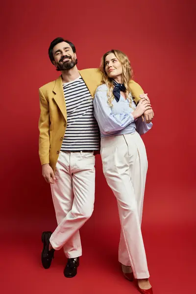 A middle aged man and woman share a joyful moment, showcasing fashion and charm. — Stock Photo