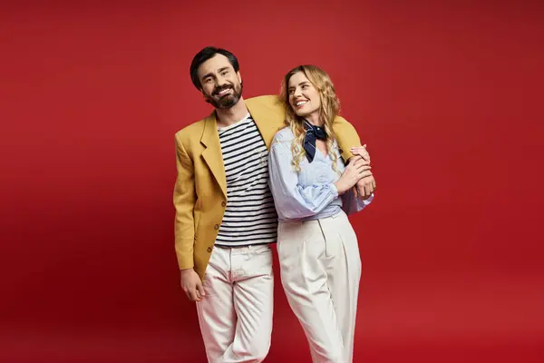 A joyful middle aged pair stands closely, sharing a moment of happiness in a striking setting. — Stock Photo