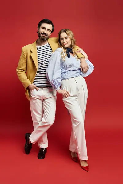 A stylish middle aged couple stands proudly in elegant, colorful outfits. — Stock Photo