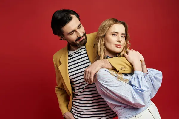 A fashionable middle aged couple displays playful chemistry while dressed elegantly. — Stock Photo