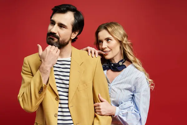 A middle aged couple showcases playful interaction while dressed in fashionable clothing. — Stock Photo