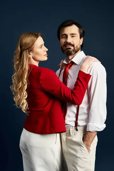 A couple radiates confidence, with the woman in a red jacket and the man in a white shirt. — Stock Photo