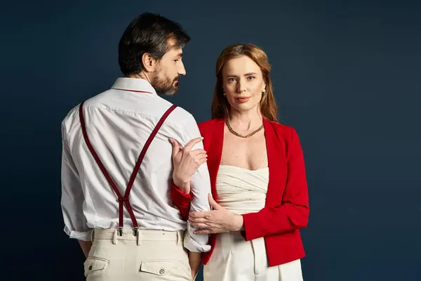 Two stylish middle aged individuals share a moment of intimacy and connection. — Stock Photo