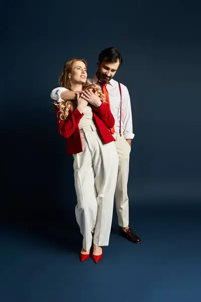 A middle aged couple shares laughter while showcasing their fashionable outfits in a studio setting. — Stock Photo