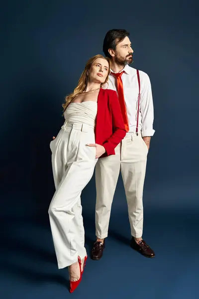 A fashionable couple stands confidently, showcasing contemporary style and elegance together. — Stock Photo