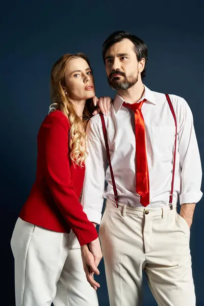 A middle aged couple dressed in fashionable clothing poses confidently with striking expressions. — Stock Photo