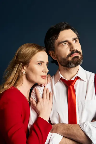 A middle aged couple shares an intimate moment, dressed in elegant attire, lost in thought. — Stock Photo