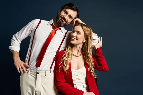The couple shares a joyful moment, showcasing their fashionable attire in a vibrant setting. — Stock Photo
