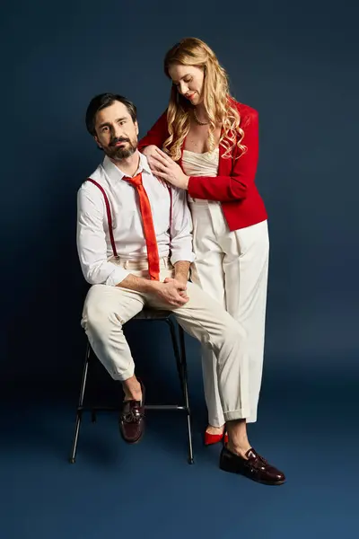 A middle aged couple poses elegantly with a warm connection in a contemporary backdrop. — Stock Photo