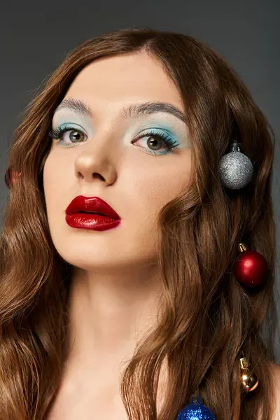 The young woman highlights a festive look with colorful decorations and bold makeup. — Stock Photo