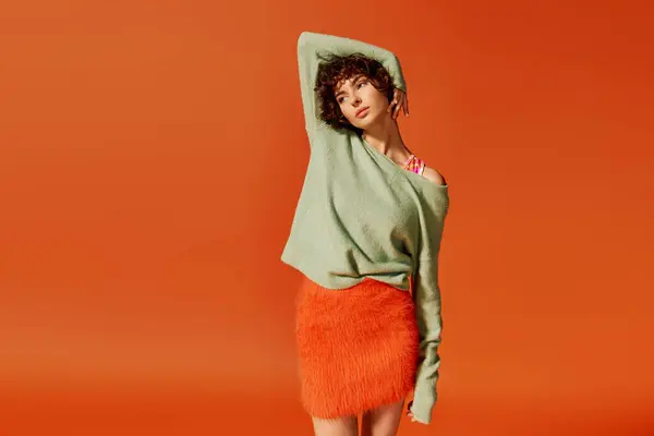A young woman showcases a mix of emotions while posing in a colorful environment. — Stock Photo