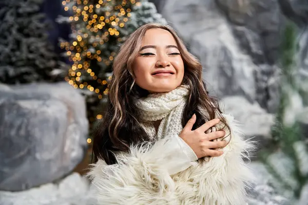 A young woman embraces the winter atmosphere, radiating joy amidst festive decorations. — Stock Photo