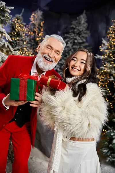 Two cheerful people share holiday joy with wrapped gifts in a snowy scene. — Stock Photo