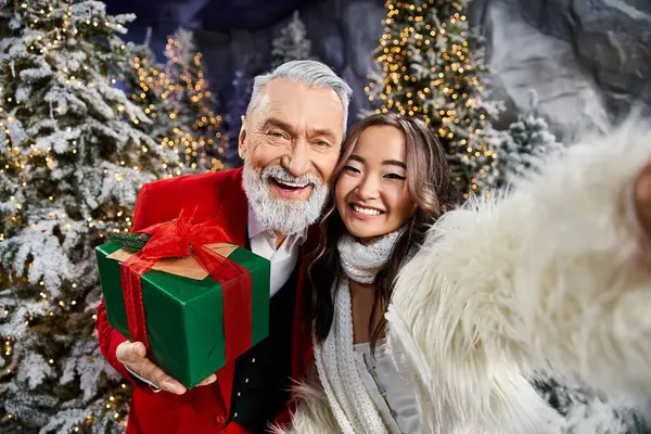 Two friends share a festive moment surrounded by Christmas trees and sparkling lights. — Stock Photo