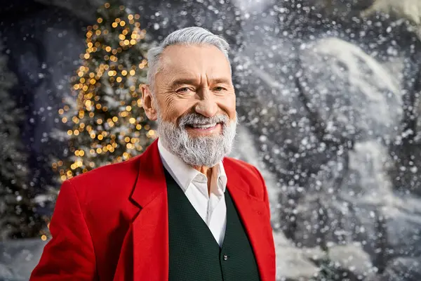 A joyful figure dressed in red enjoys the holiday season amid a snowy, festive environment. — Stock Photo