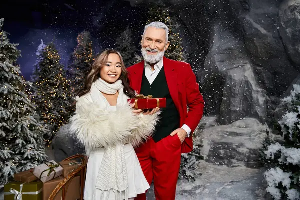 Two cheerful friends in festive attire enjoy a joyful moment by Christmas decorations. — Stock Photo