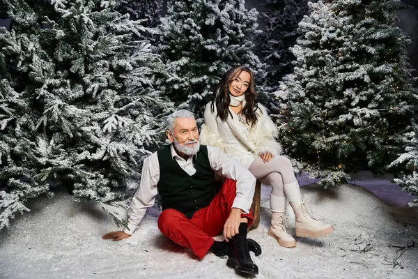 A joyful moment features a man and a woman enjoying Christmas in a snowy wonderland. — Stock Photo